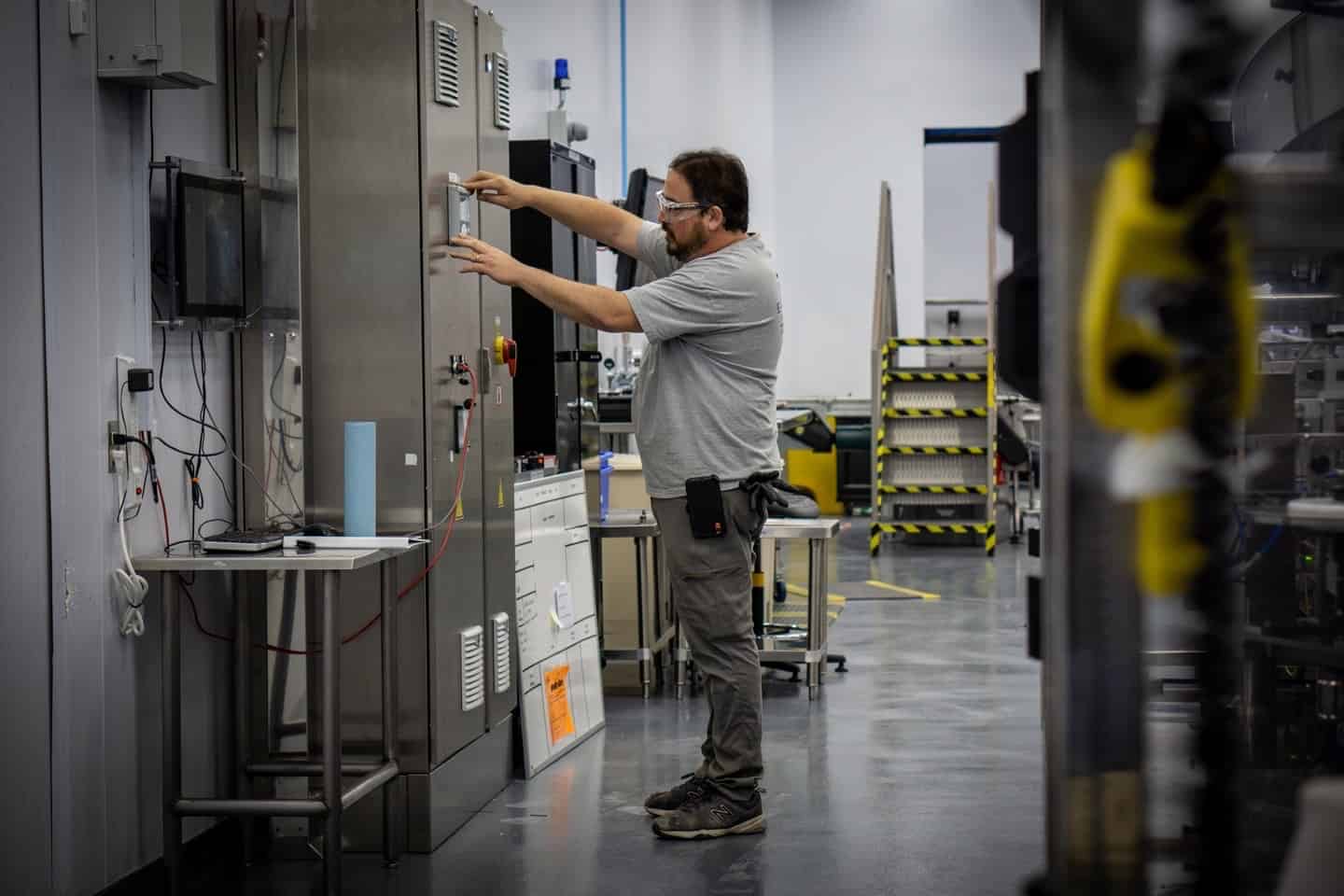 Electrician working on industrial electrical equipment
