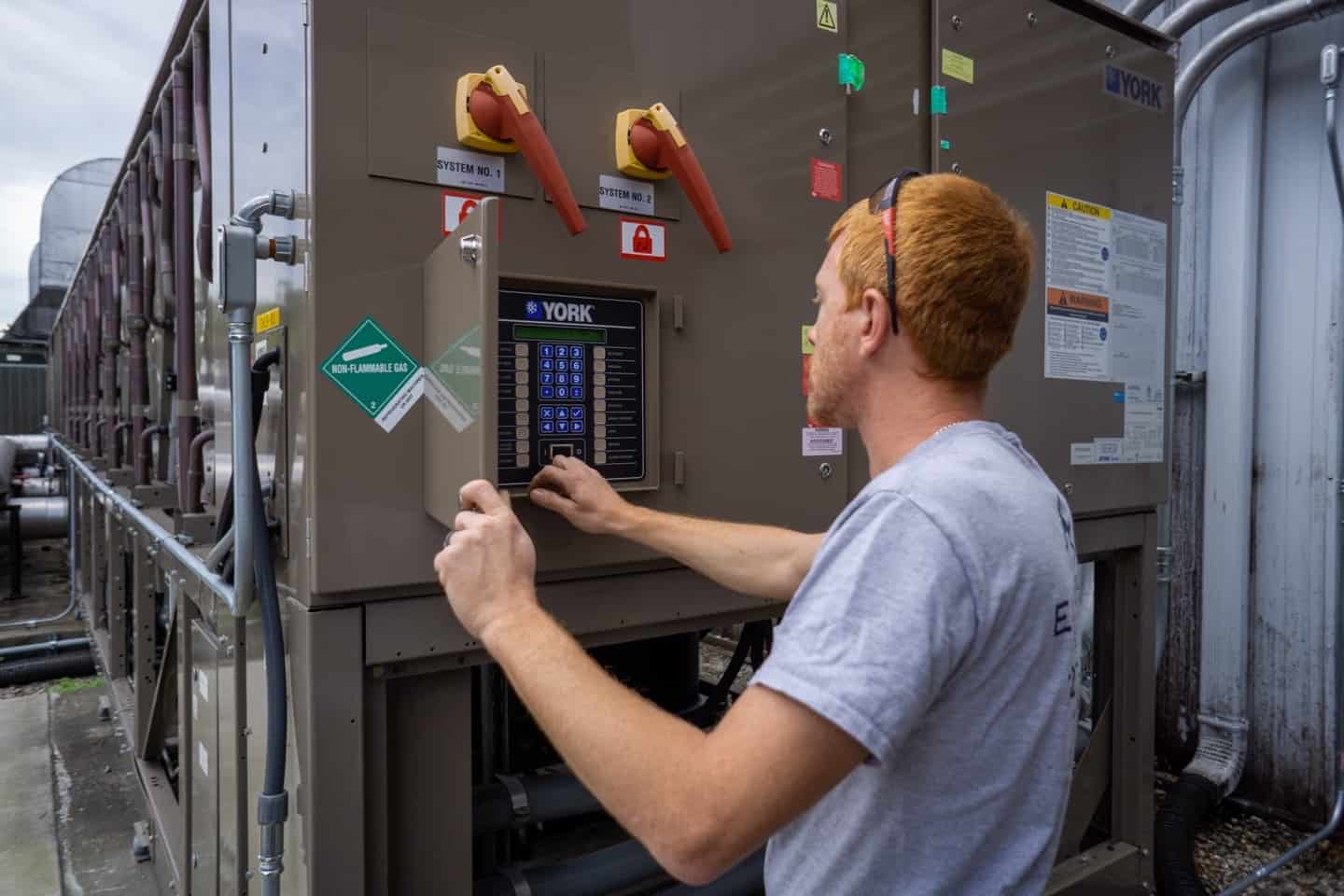 Technician documenting industrial electrical equipment