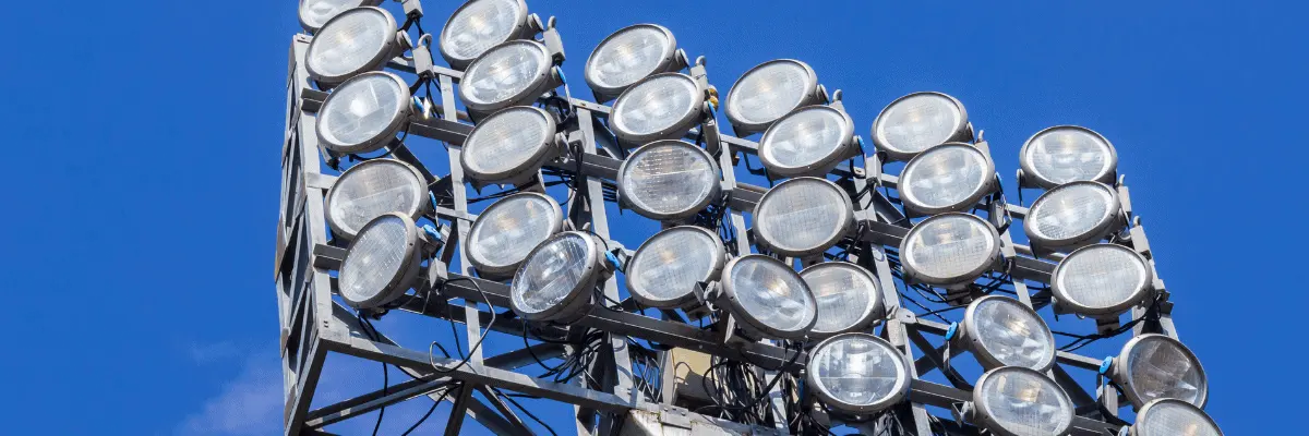 stadium lights against a blue sky
