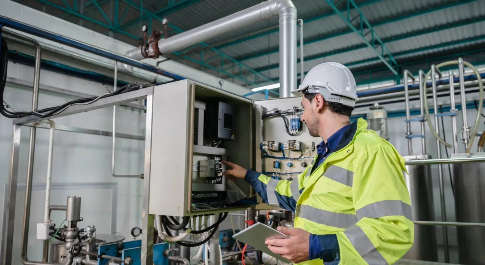 East-West technician reviewing commercial electrical equipment