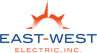 Logo of East-West Electric, Inc. featuring a stylized sun with orange rays peeking over a horizon. The sun is positioned above the blue text "EAST-WEST" and the orange text "ELECTRIC, INC." below it, symbolizing the trusted electricians in Clearwater.